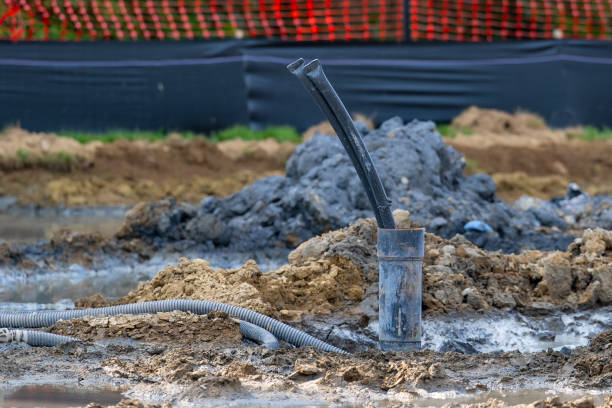 istock Casing pipe with polyethylene ground loop pipes in the process of being installed in a new geothermal well field. 2162588188