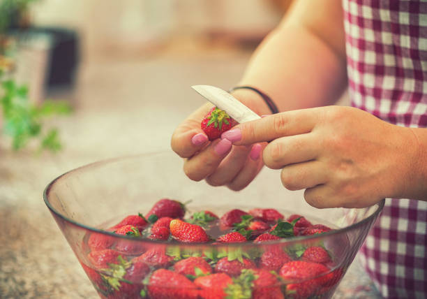 istock Washing strawberries for making homemade pie 2162588862