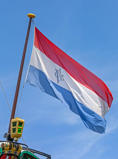 Amsterdam, Netherlands - May 17, 2018: Big Flag at VOC Ship Stern Amsterdam From 1749 Replica Historical Nautical Exhibition in Front of Maritime Museum Sunny Spring Day.
