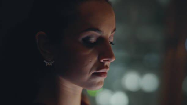 istock Pensive woman looking window using smartphone in night cityscape flat closeup 2162592073