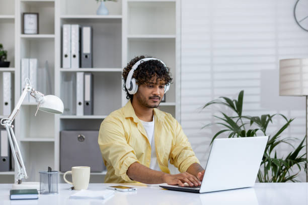 istock Young professional working from home with headphones and laptop 2162592120