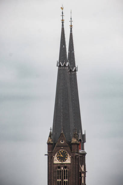 Close up of the two towers of the Maria van Jessekerk, located in the city center of Delft, known for i's porcelain and university engineering program. Delft is located between Rotterdam and The Hague.