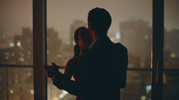istock Silhouettes couple dancing date evening cityscape kitchen closeup. Spouses dance 2162594413