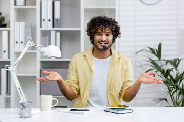 istock Smiling man with headset having a video call in home office environment 2162594434