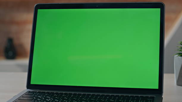 istock Empty chroma key laptop display on workplace desk closeup. Green screen computer 2162594968
