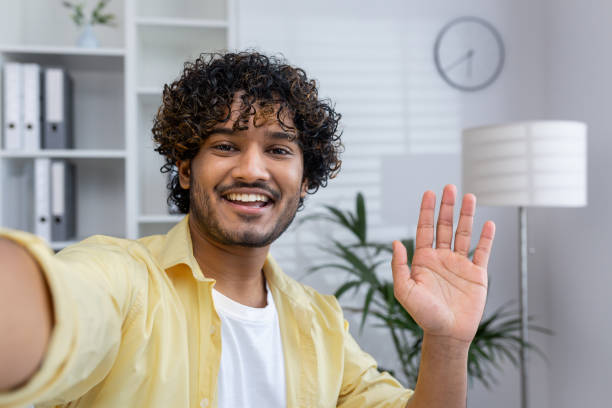 istock Smiling man waving during a video call in a home office setting 2162595746
