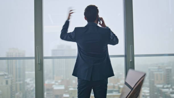 istock Angry entrepreneur disappointed call gesturing hand cityscape office back view 2162595810