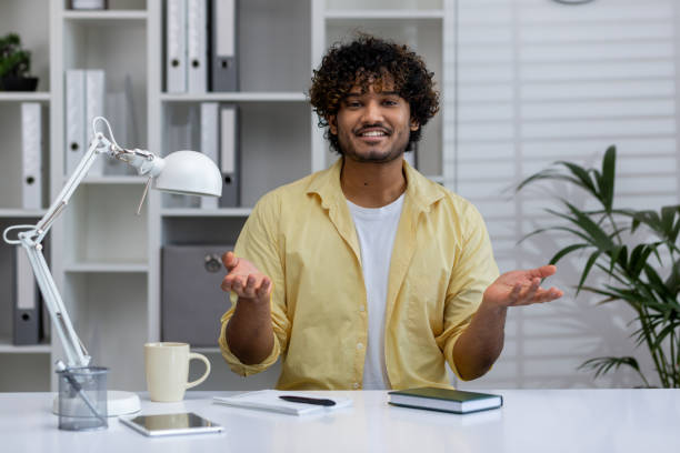 Young professional doing video call in modern office setting with relaxed ambiance