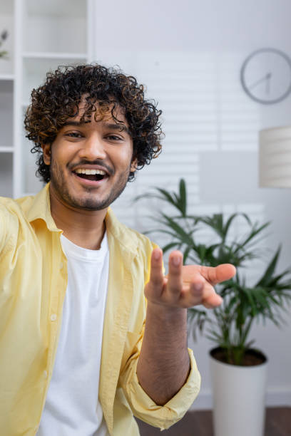 istock Smiling man making a video call from home, engaging in conversation 2162596254