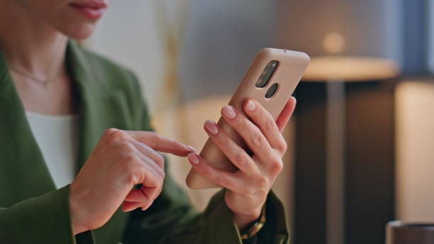 istock Office manager swipe screen at work closeup. Woman hands scrolling mobile phone 2162597119