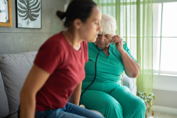 istock Experienced Female GP Doing Home Visit. Home Healthcare. 2162598018