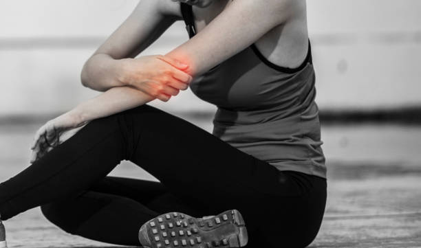 istock Young woman with elbow pain outdoors During exercise 2162599669