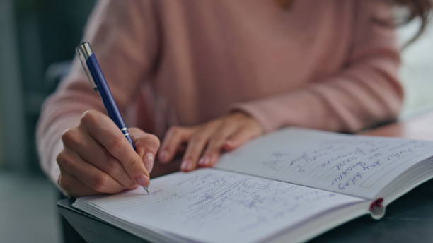 istock Accountant hands writing notebook at light workplace closeup. Woman making notes 2162605721