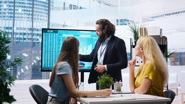 istock Broker agent showing statistical graphs about stock exchange shares 2162606471