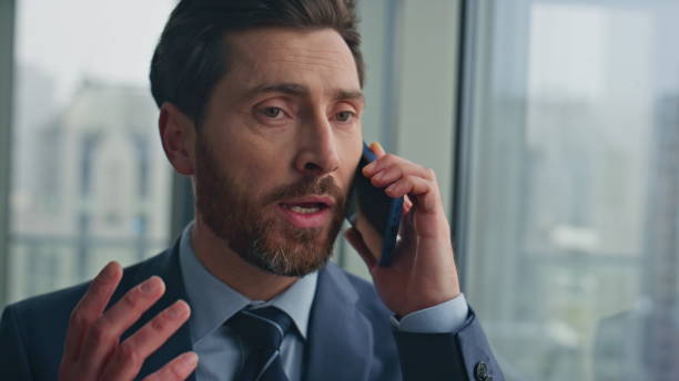 istock Confident businessman speaking cellphone at panoramic window office closeup 2162609508
