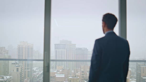 istock Thoughtful boss resting office contemplating gloomy city back view. Man thinking 2162609765
