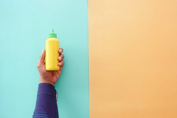 istock top view of holding a mustard mayonnaise container 2162609970
