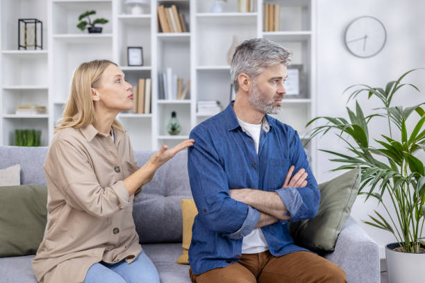istock Couple having a serious discussion on the couch at home 2162611585