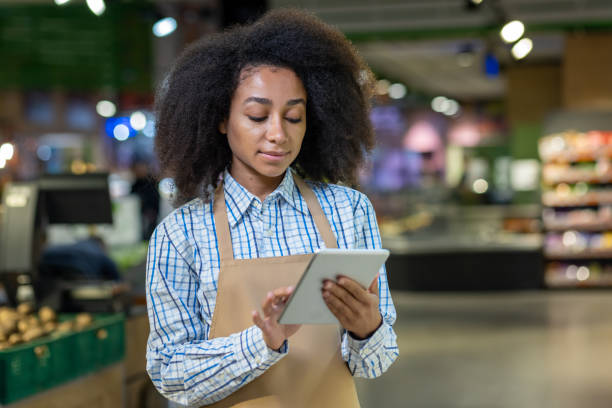istock Retail worker using digital tablet in supermarket for inventory management 2162612030