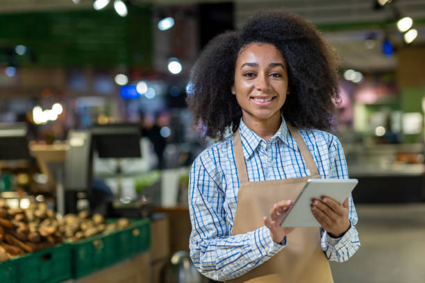 istock Confident grocery store employee using a digital tablet in a modern supermarket 2162612510