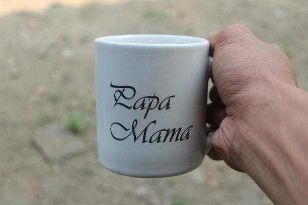 istock the hand holding a ceramic mug that says mama papa 2162613398
