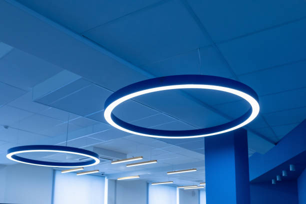 istock Ceiling with round modern LED lamps. Suspended fluorescent lights under the ceiling. Careful energy consumption, energy saving concept 2162615636