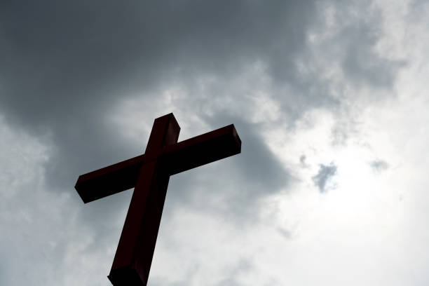Religious cross under the cloudy sky.