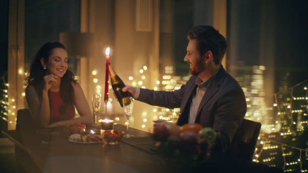 istock Enamoured pair celebrating anniversary big windows hotel romantic date closeup 2162618573