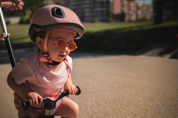 istock baby strolls through the park on his scooter 2162618993