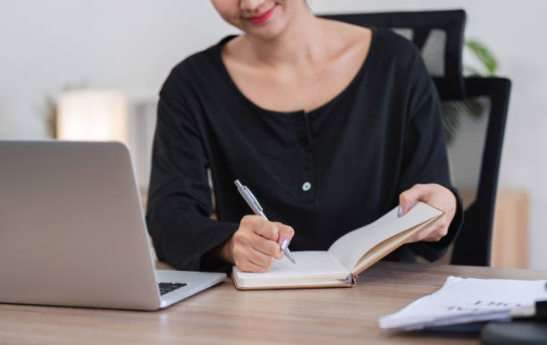 istock Young Accountant Working on Financial Documents at Home with Laptop and Notebook, Focused on Budgeting and Planning 2162619416