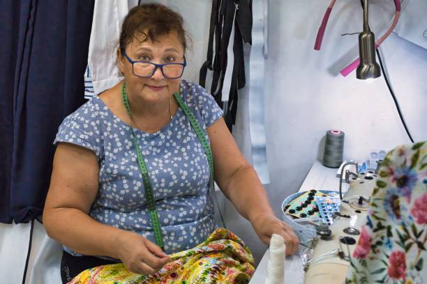 A woman seamstress works in a small workshop.