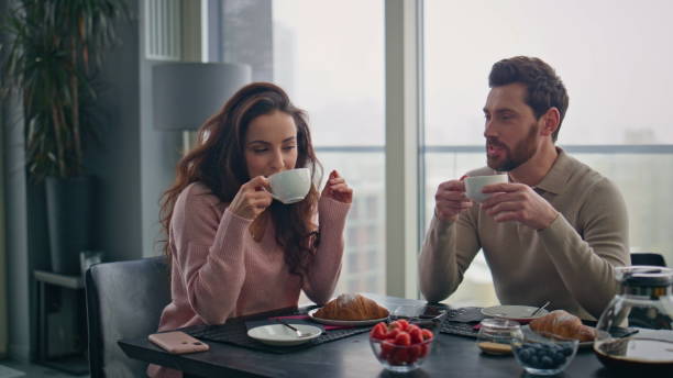 istock Talking lovers drinking coffee sitting home closeup. Couple enjoying breakfast 2162620965
