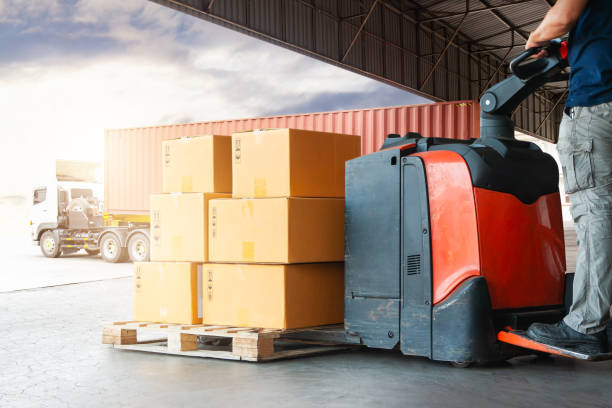 istock Warehouse Workers Loading a Package Boxes on Pallets at Warehouse. Electric Forklift Pallet Jack Loader. Distribution Storage Warehouse. Supply Chain, Supplies Warehouse Shipping. Logistics. 2162622354