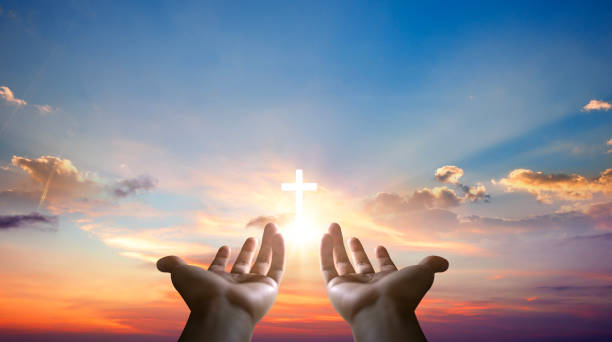 istock Hands holding cross on sunset sky background. Christian religion concept. 2162622687