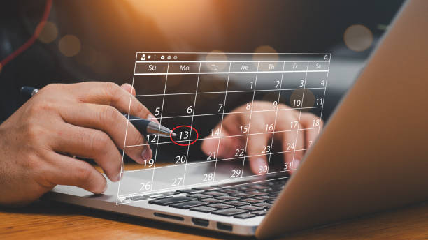 istock Businessman manages time for effective work. Time management concept. Calendar on the virtual screen interface. Highlight appointment reminders and meeting agenda on the calendar. 2162623761
