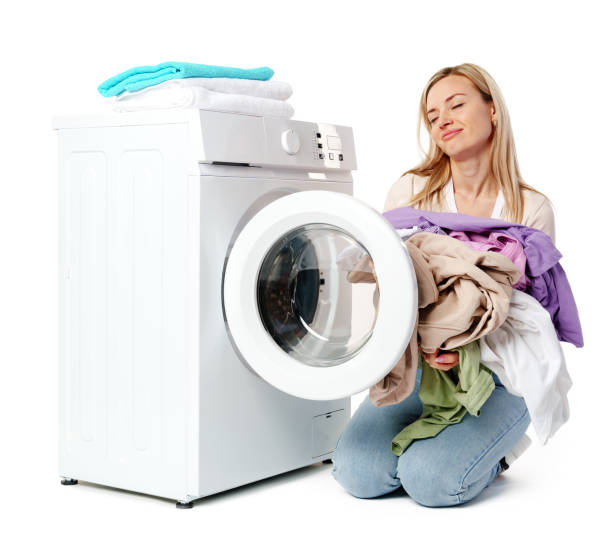 istock Woman Loading Clothes Into White Washing Machine on white background 2162624347