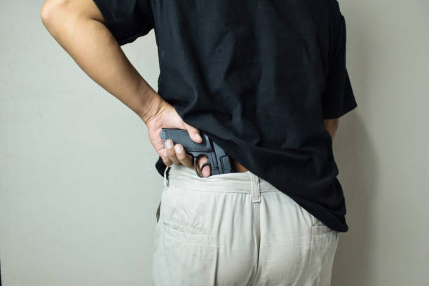 istock Man taking gun from waist 2162625666