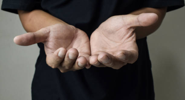istock Man praying to god with hands together on beige background 2162625697