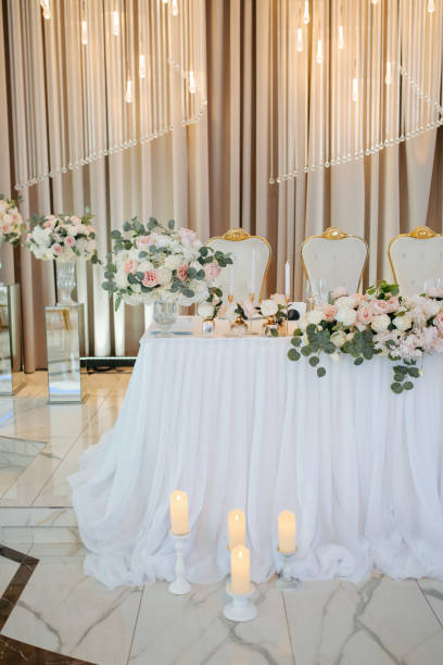 istock table in a restaurant decorated with flowers and candles. 2162625953