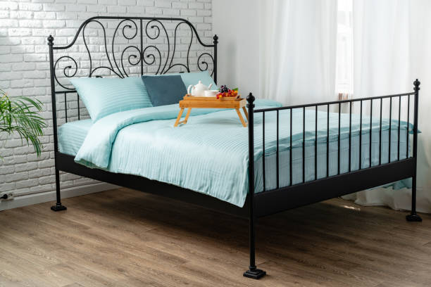 Cozy blue bedding with natural light in a domestic room.