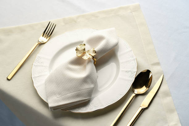 istock Gold Leaf Napkin Ring on White Plate and Placemat 2162626809