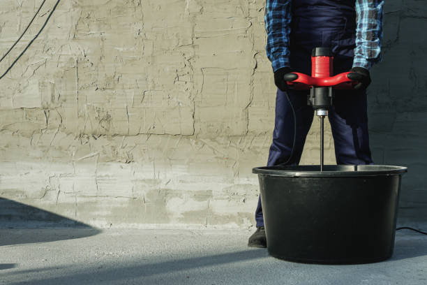 istock the builder mixes the cement mixture with a mixer 2162627557