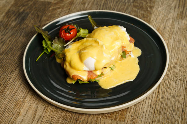 istock Eggs Benedict with salmon on a wooden table 2162628484