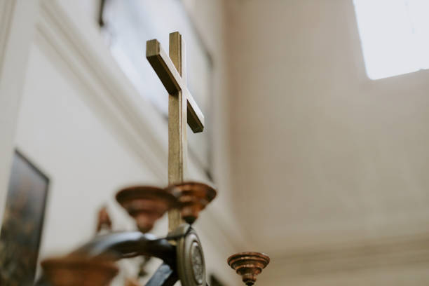 Baptismal crosses hang on the large cross of the baptismal font lid in the church. Orthodox traditions and sacraments.