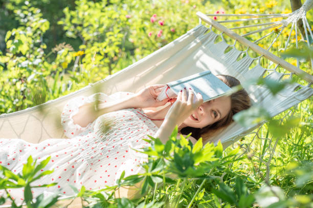 istock Young woman relaxing in a hammock 2162629683