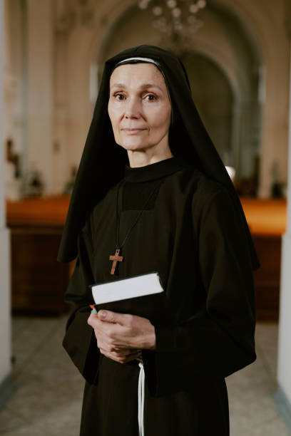 istock Mature Nun Standing In Church 2162629785