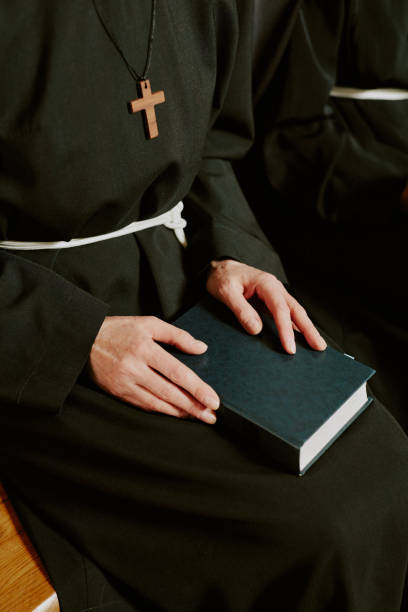 istock Unrecognizable Nun Sitting On Bench 2162629788