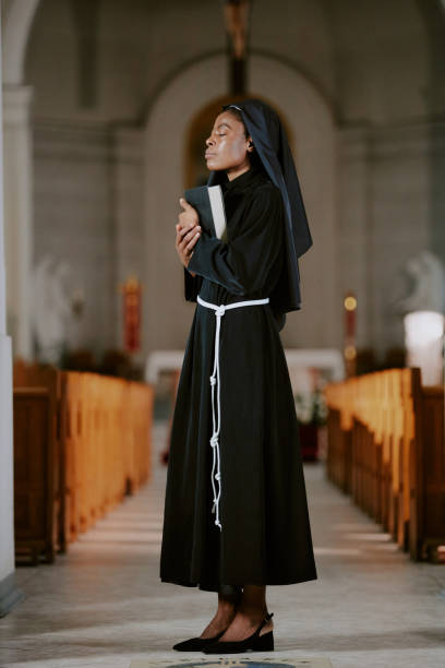 istock Young Black Nun Standing In Church Building 2162629789
