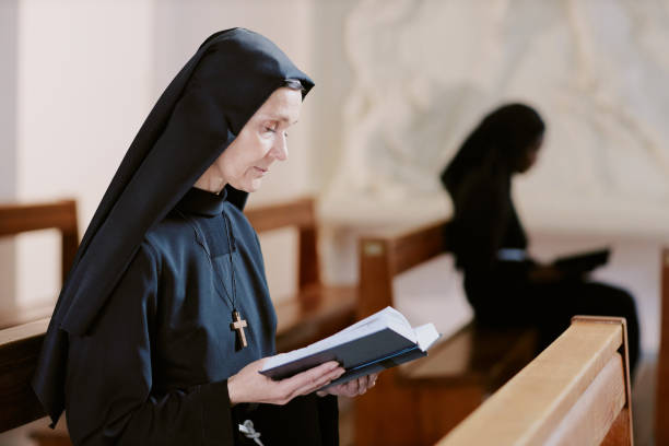 istock Senior Nun Reading Bible 2162629851