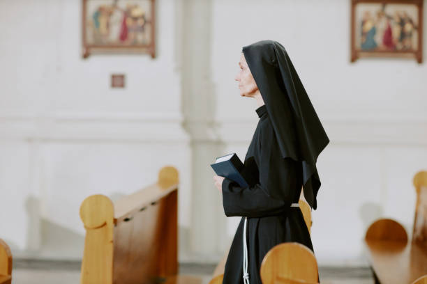istock Mature Catholic Nun Walking Along Church 2162629889